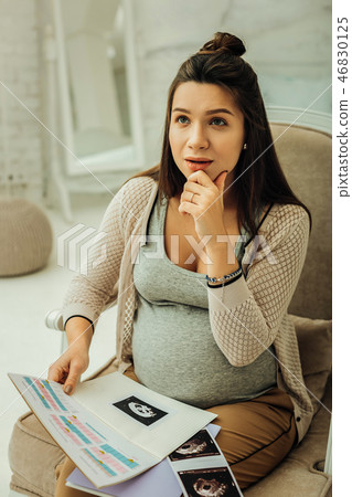 Pregnant woman thinking on the name for her future child 46830125