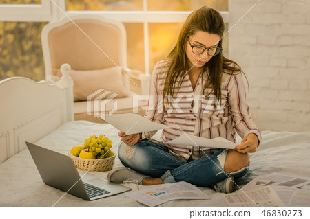 Pregnant woman managing the working process from home 46830273
