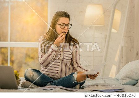 Pregnant woman sitting in her bed and working Pregnant woman sitting in her bed and working 46830276