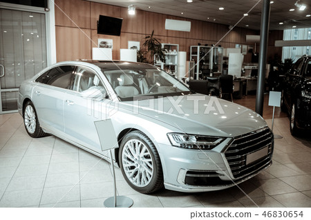 Nice light silver passenger car standing in car dealers Nice light silver passenger car standing in car dealers 46830654