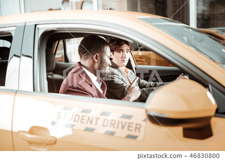 Inexperienced young driver feeling worried sitting in the car Inexperienced young driver feeling worried sitting in the car 46830800