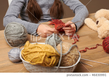 Child is learning to knit. Colorful wool yarns  46830991