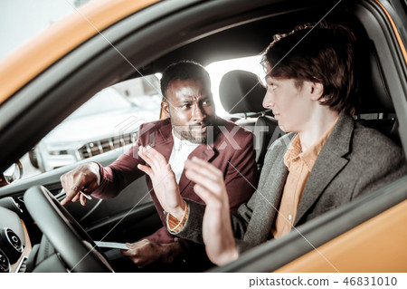 Serious bearded driving teacher telling the main rules to his student Serious bearded driving teacher telling the main rules to his student 46831010