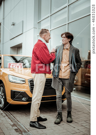 Thankful son wearing grey coat and scarf shaking hand of father Thankful son wearing grey coat and scarf shaking hand of father 46831028