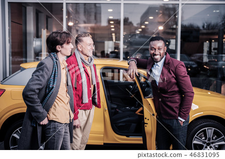Sales manager smiling broadly while consulting his clients Sales manager smiling broadly while consulting his clients 46831095