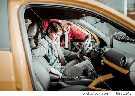 Father and son feeling responsible while choosing new car Father and son feeling responsible while choosing new car 46831142