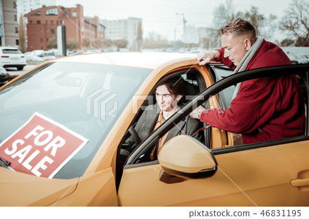 Student feeling excited while choosing new car with father Student feeling excited while choosing new car with father 46831195