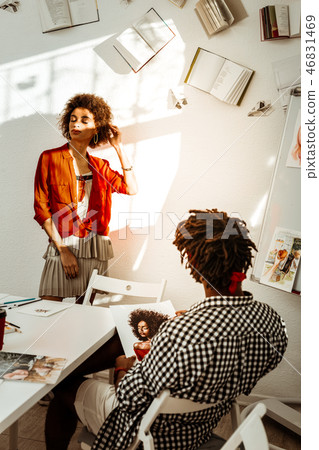 Man wearing squared shirt drawing portrait of his girlfriend 46831469