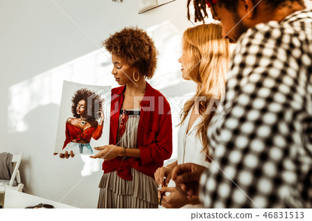Man and woman looking at nice beautiful portrait of their friend 46831513