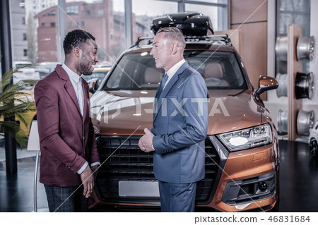 Handsome African-American businessman buying big new car 46831684