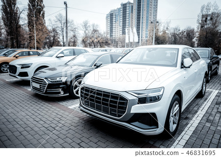 New passenger cars of corporate company standing outside New passenger cars of corporate company standing outside 46831695