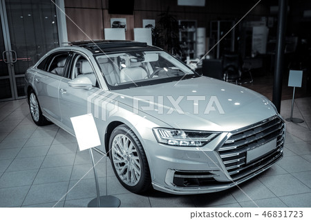 Nice silver car standing in light spacious salon of car dealers Nice silver car standing in light spacious salon of car dealers 46831723