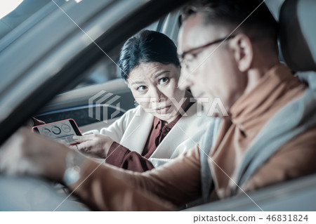 Husband wearing glasses driving while going home with wife Husband wearing glasses driving while going home with wife 46831824