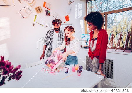 Young art student giving master class in marble painting Young art student giving master class in marble painting 46831828