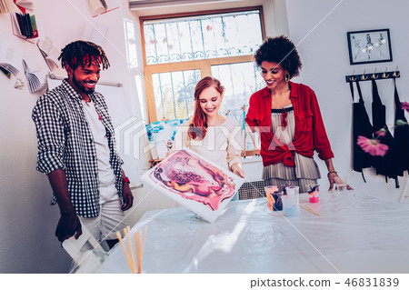 Three cheerful workers of art department feeling satisfied Three cheerful workers of art department feeling satisfied 46831839