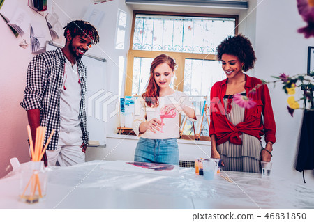 Red-haired artist giving interesting master class in marble painting Red-haired artist giving interesting master class in marble painting 46831850