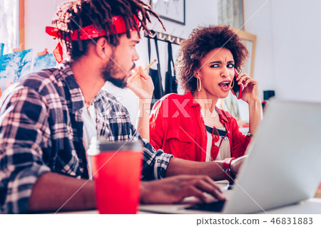 Curly pretty dark-haired female freelancer feeling overemotional 46831883