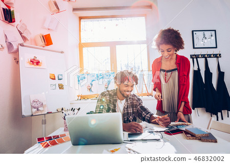 Man and woman working in light painting studio together Man and woman working in light painting studio together 46832002