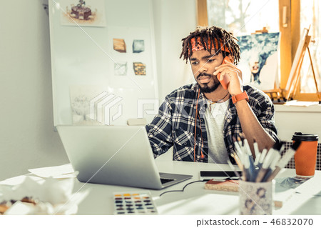 Dark-eyed interior designer with dreadlocks feeling concerned 46832070