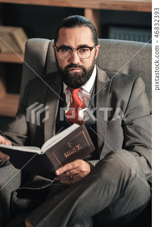 Businessman feeling thoughtful while reading the Bible Businessman feeling thoughtful while reading the Bible 46832393