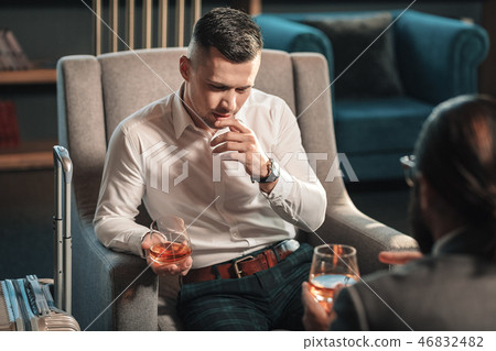 Young lawyer drinking whisky with client giving consultation Young lawyer drinking whisky with client giving consultation 46832482