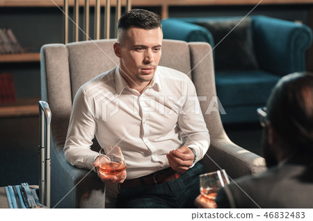 Young handsome promising lawyer drinking whisky with client Young handsome promising lawyer drinking whisky with client 46832483