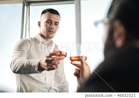 Two business partners drinking some cognac after successful negotiation 46832521
