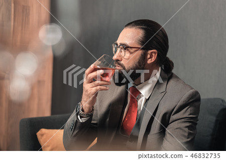 Successful man wearing nice hand watch holding glass of whisky Successful man wearing nice hand watch holding glass of whisky 46832735