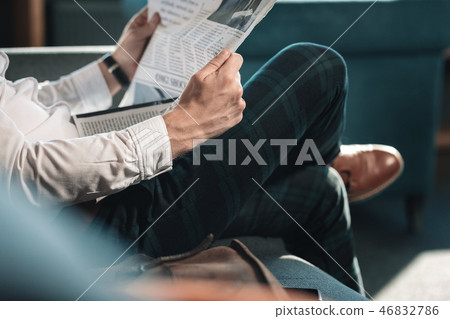 Close up of smart successful mature man holding newspaper 46832786