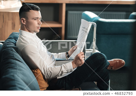 Stylish handsome businessman wearing brown leather shoes reading news 46832793