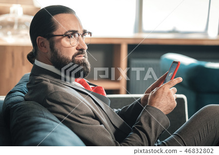 Mature stylish businessman wearing dark grey costume and red tie Mature stylish businessman wearing dark grey costume and red tie 46832802
