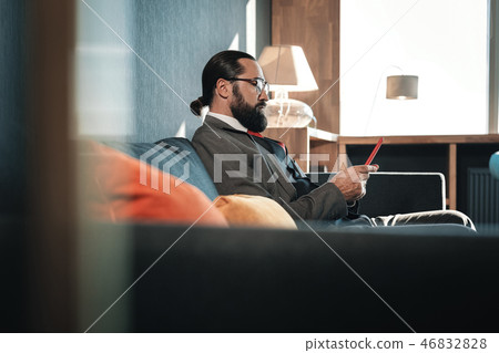 Man wearing business attire using his smartphone having some free time 46832828