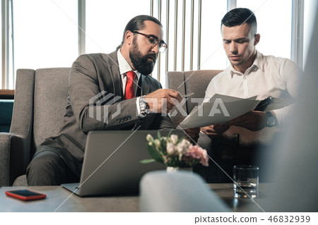 Bearded businessman giving pen to his partner signing contract 46832939