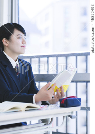 High school girl reading reference book 46833498