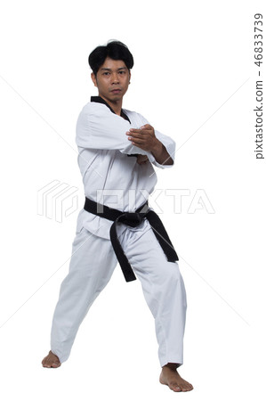 Master Black Belt TaeKwonDo handsome man instructor Teacher fighter show hit pose, studio lighting white background isolated. White formal fighting suit, motion blur hand foots on taekwondo post. Master Black Belt TaeKwonDo handsome man instructor Teacher fighter show hit pose, studio lighting white background isolated. White formal fighting suit, motion blur hand foots on taekwondo post. 46833739