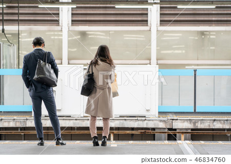 business woman and man stand on platform 46834760