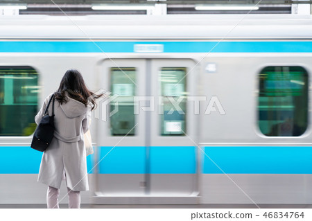business woman with blur train 46834764