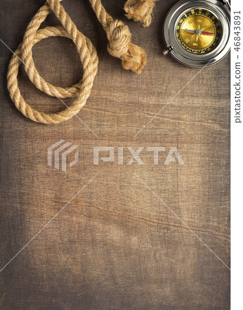 ship compass and rope at wooden background ship compass and rope at wooden background 46843891