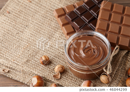 Chocolate spread with hazelnuts on sack background Chocolate spread with hazelnuts on sack background 46844299