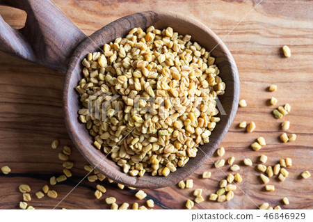 Fenugreek seeds on a wooden spoon, top view Fenugreek seeds on a wooden spoon, top view 46846929