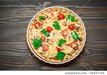 Traditional quiche tart in baking form with filling Traditional quiche tart in baking form with filling 46847298