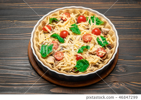 Traditional quiche tart in baking form with filling Traditional quiche tart in baking form with filling 46847299
