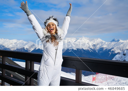 Portrait of a beautiful woman in the middle of the snowy mountai 46849685