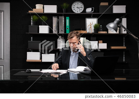 young man in business clothes working at computer Desk with phone and documents young man in business clothes working at computer Desk with phone and documents 46850083
