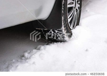 Close up of a cars tires on a snowy road 46850698