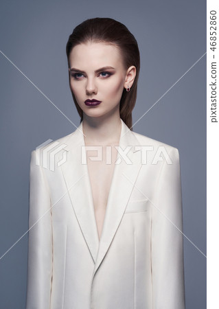Elegant woman in white jacket 46852860