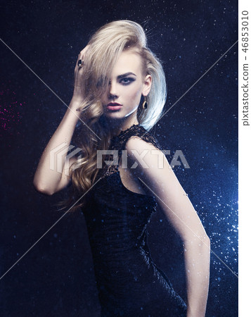 Beautiful woman through the wet window Beautiful woman through the wet window 46853010