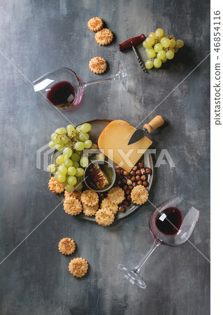 Cheese and grapes appetizer 46854116