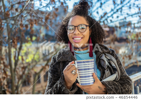 Smiling dark-skinned lady having light blue eyeshadow 46854446
