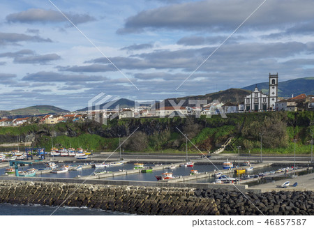 View of colorful quay and port of village Rabo de Peixe with boats, church and houses in Sao Miguel View of colorful quay and port of village Rabo de Peixe with boats, church and houses in Sao Miguel 46857587